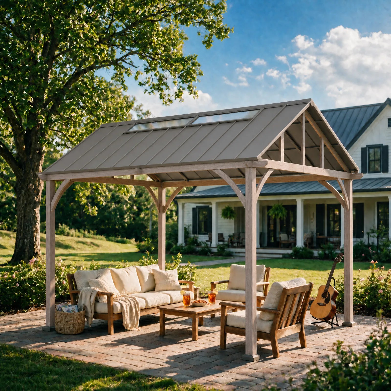 A large wooden patio cabana with a metal roof and skylights, furnished with a sofa, chairs, and a coffee table on a brick patio in a backyard setting.